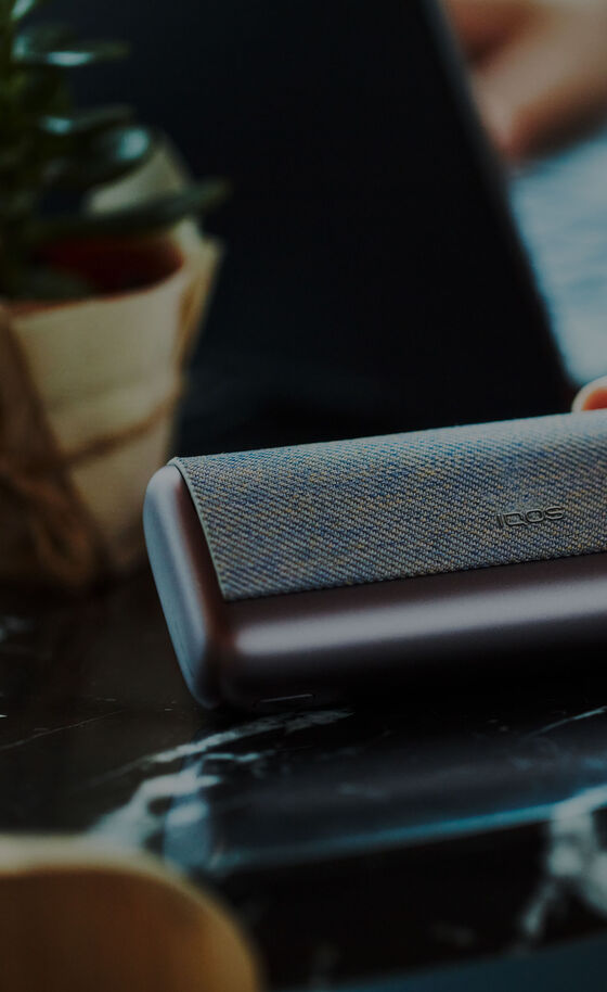 A jade green IQOS ILUMA PRIME Holder and Pocket Charger.